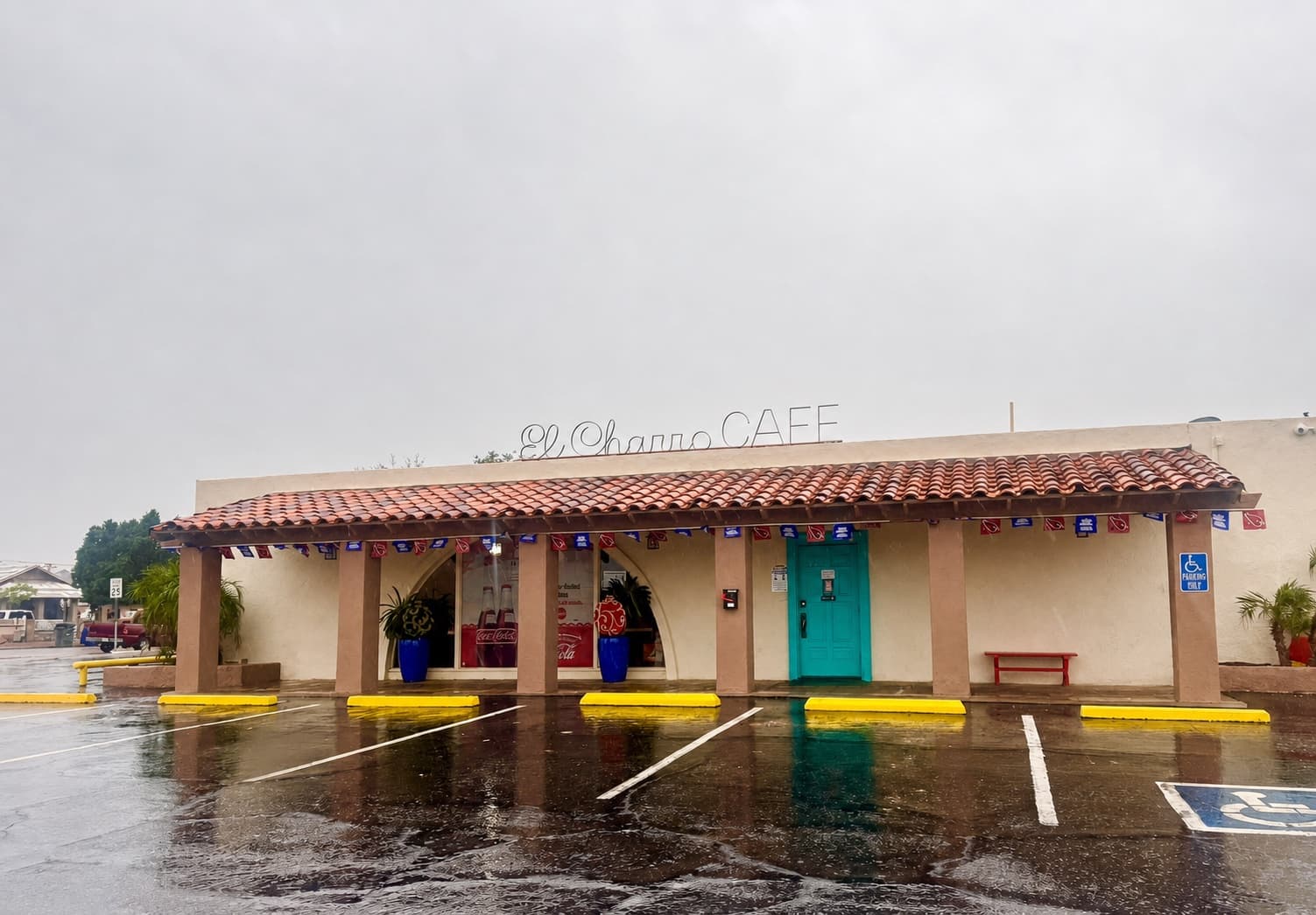 El Charro Cafe exterior on a rainy day with reflections in the parking lot