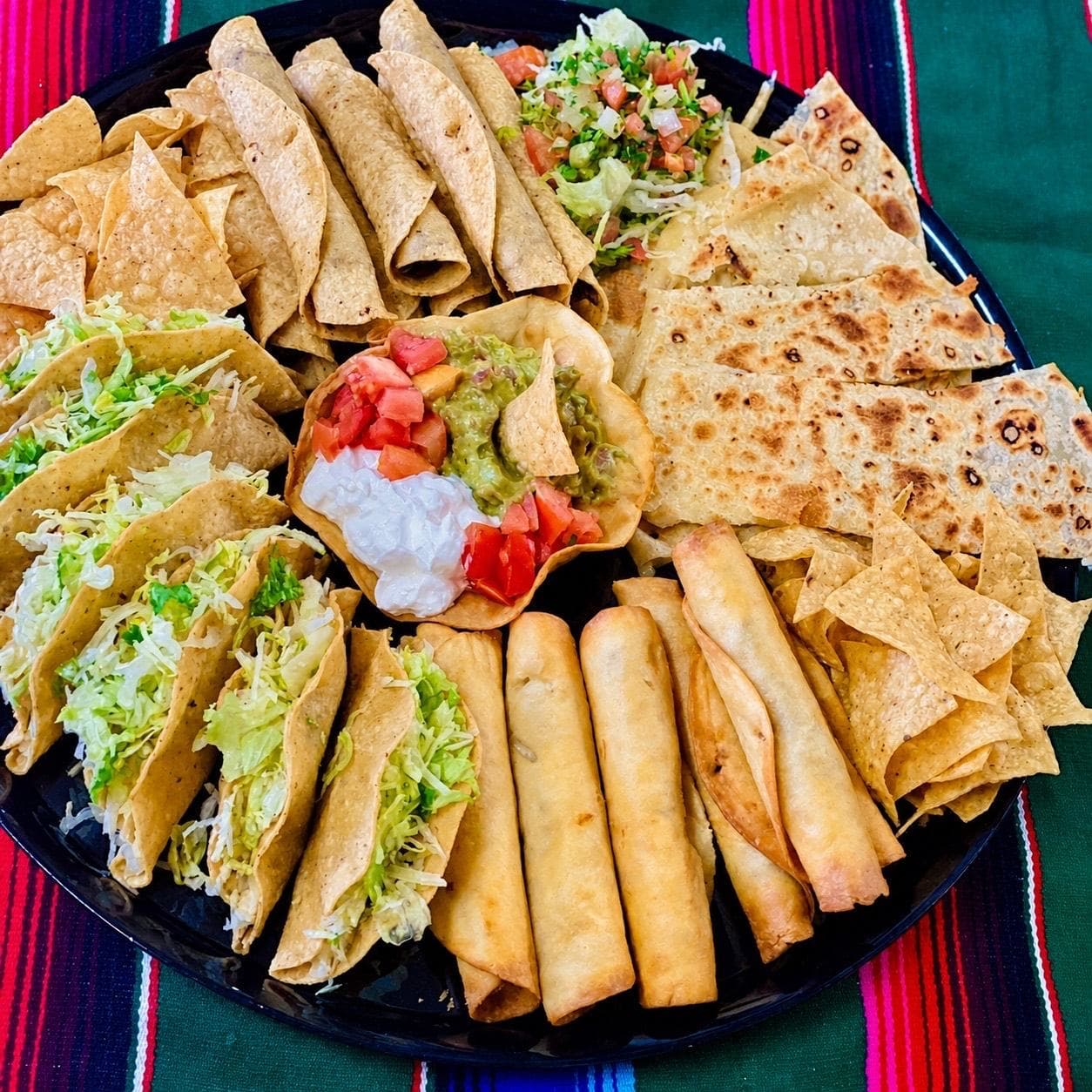 El Charro Cafe sampler platter with tacos, rolled tacos, quesadillas, chips, and dips