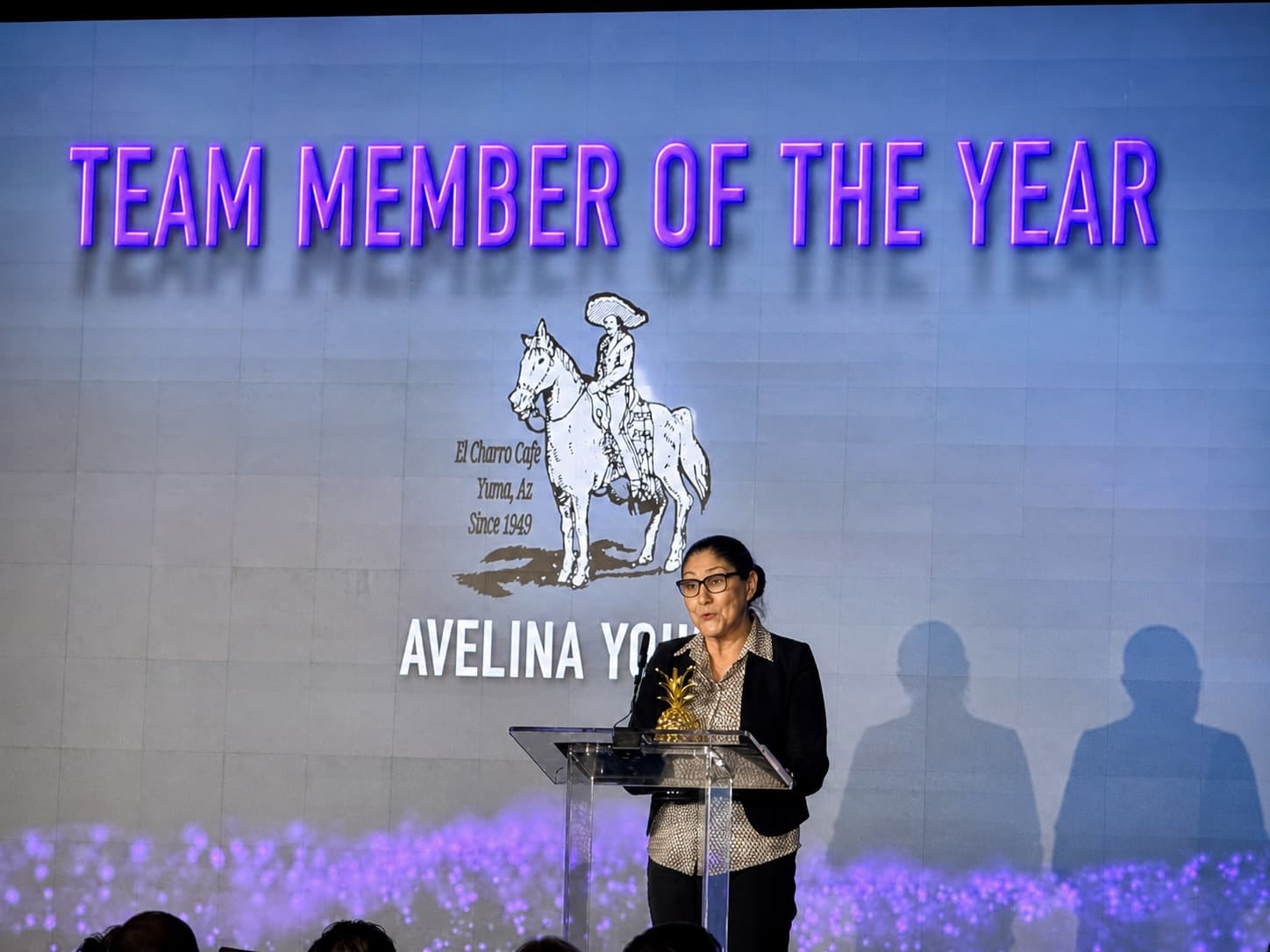 Avelina accepting a Team Member of the Year award for El Charro Cafe