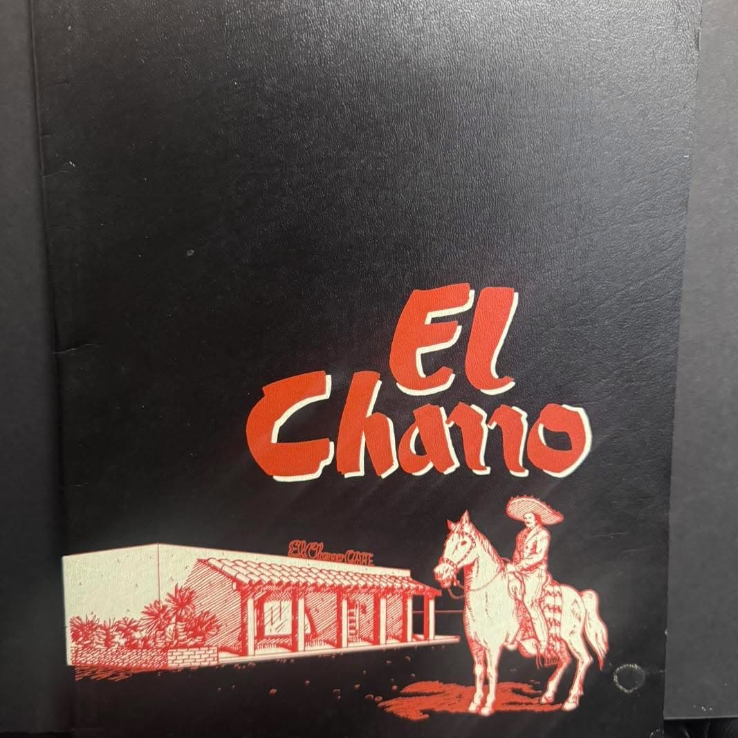 Vintage black El Charro menu cover with red restaurant illustration and horse rider logo