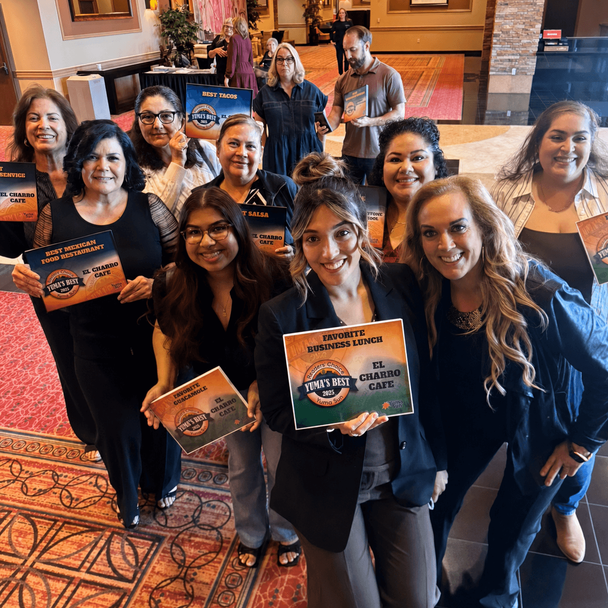 El Charro team members holding Yuma's Best award frames