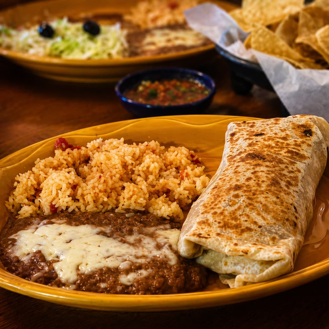 Burrito plate with beans, rice, chips, and salsa at El Charro Cafe